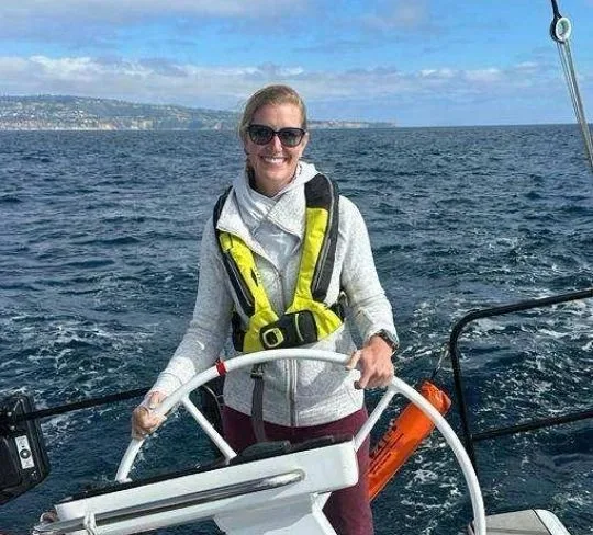 Amanda Haley at the helm of a sailing yacht